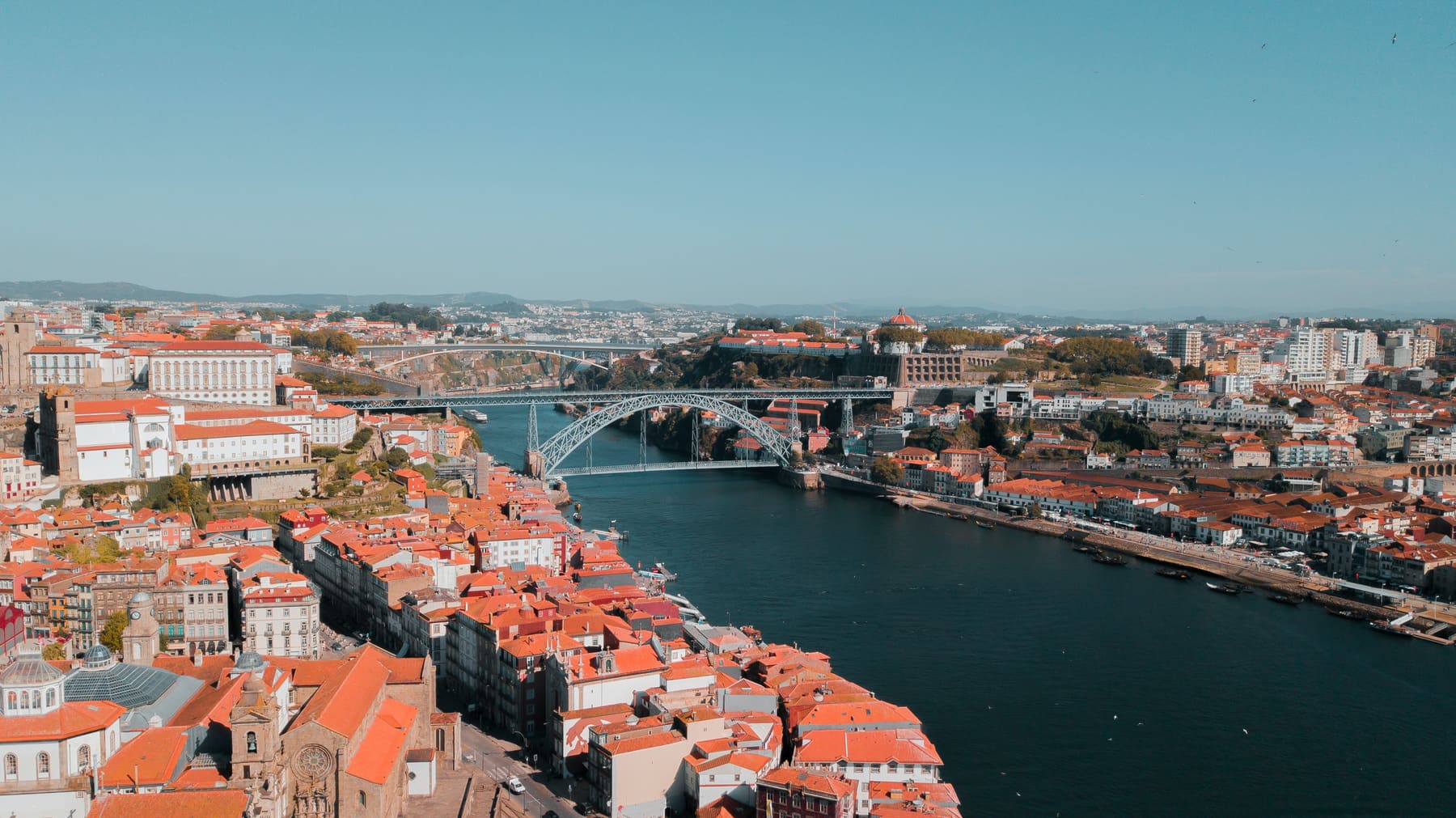 Aerial view of Porto: the Douro river, the Dom Luís I bridge and the city's red rooftops